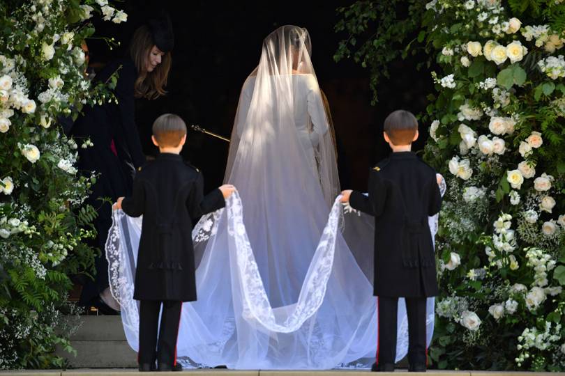 The bride enters St George's Chapel flanked by 10 bridesmaids and page boys, including Prince George and Princess Charlotte.