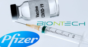 In this file photo taken on November 23, 2020 is pictured a bottle reading “Vaccine Covid-19” next to US pharmaceutical company Pfizer and German biotechnology company BioNTech logos on November 23, 2020. JOEL SAGET / AFP