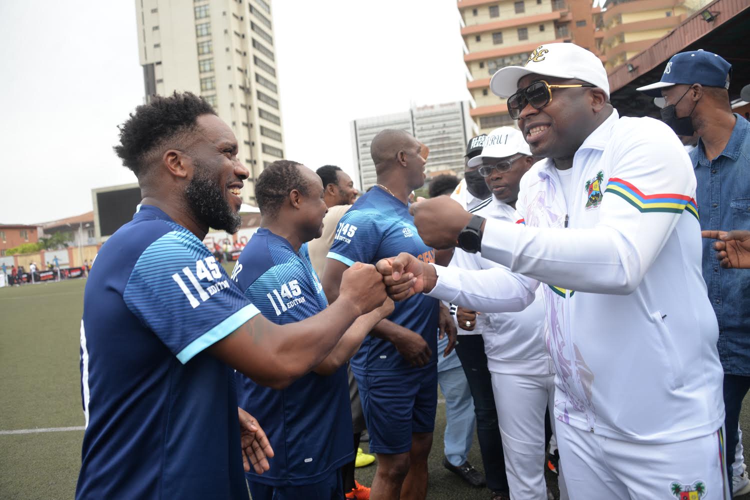 (R-L): Photo shows His Royal Majesty, HRM, Oba Saheed Ademola Elegushi (Kusenla III), the Elegushi of Ikateland, in a handshake with ex-super eagles midfielder and captain, Austin Jay Jay Okocha at the Elegushi Peace Cup tournament in Lagos, sponsored by Fearless Energy drink, a product of Rite Foods Limited