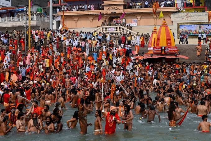 Naga Sadhus (Hindu holy men) take a holy dip in the waters of the Ganges River on the day of Shahi Snan (royal bath) during the ongoing religious Kumbh Mela festival, in Haridwar on April 12, 2021. (AFP/Money Sharma)