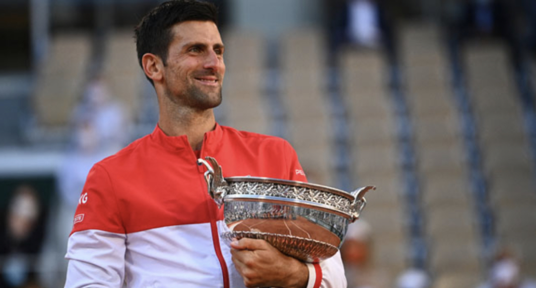Serbia’s Novak Djokovic poses with The Mousquetaires Cup (The Musketeers) after winning against Greece’s Stefanos Tsitsipas at the end of their men’s final tennis match on Day 15 of The Roland Garros 2021 French Open tennis tournament in Paris on June 13, 2021. Anne-Christine POUJOULAT / AFP