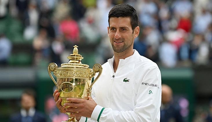 Serbia's Novak Djokovic holds the winner's trophy after beating Italy's Matteo Berrettini during their men's singles final match on the thirteenth day of the 2021 Wimbledon Championships at The All England Tennis Club in Wimbledon, southwest London. Photo: AFP