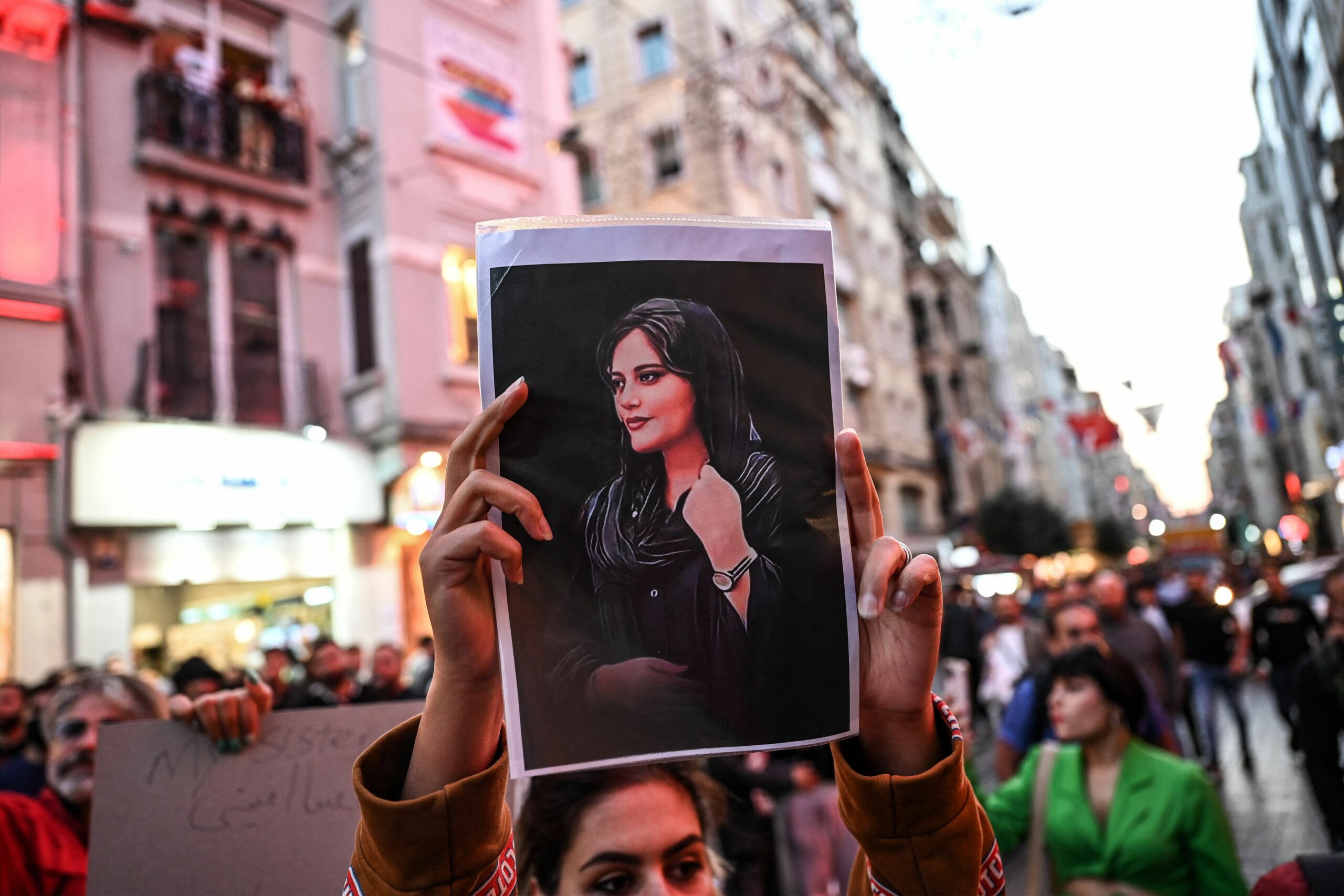 iran-protester-holds-a-portrait-of-mahsa-amini-during-a-news-photo-1663844952